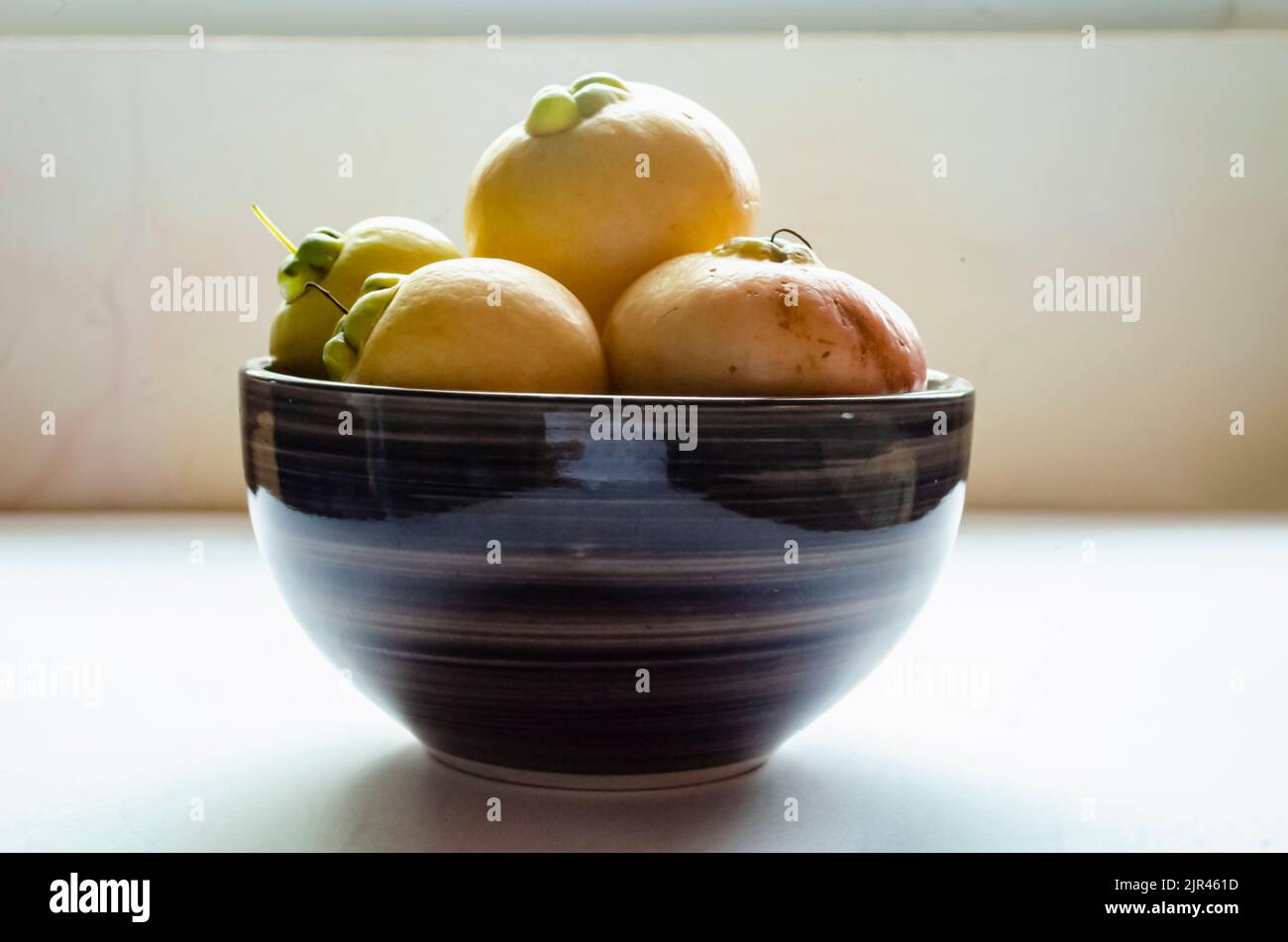 Side View Of Rose Apples In Dish Stock Photo