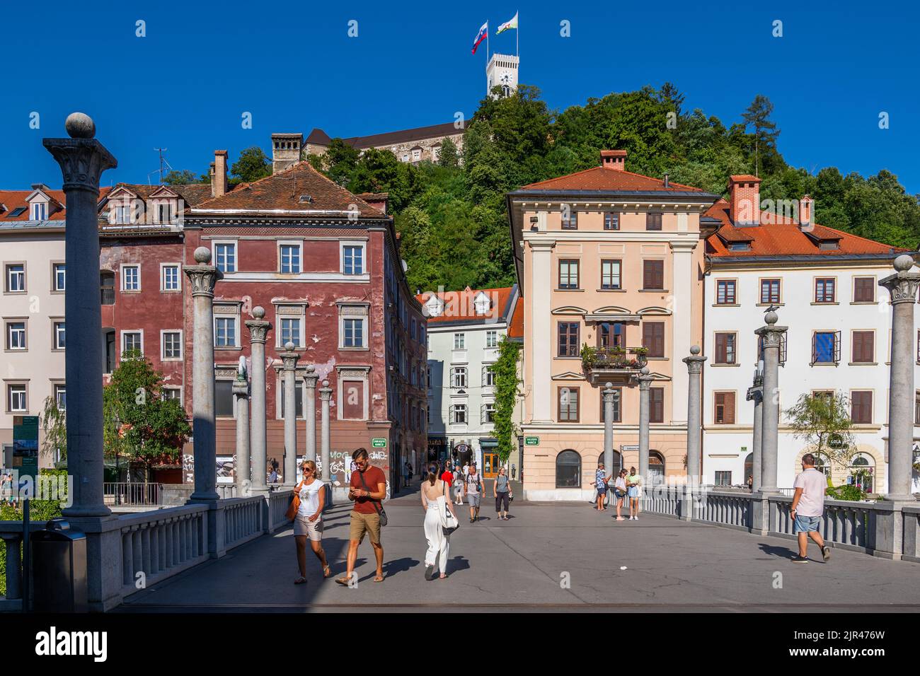 Ljubljana, Slovenia - July 13, 2022: View to the Old Town and castle hill from the Cobblers Bridge (Shoemakers), city landmarks. Stock Photo