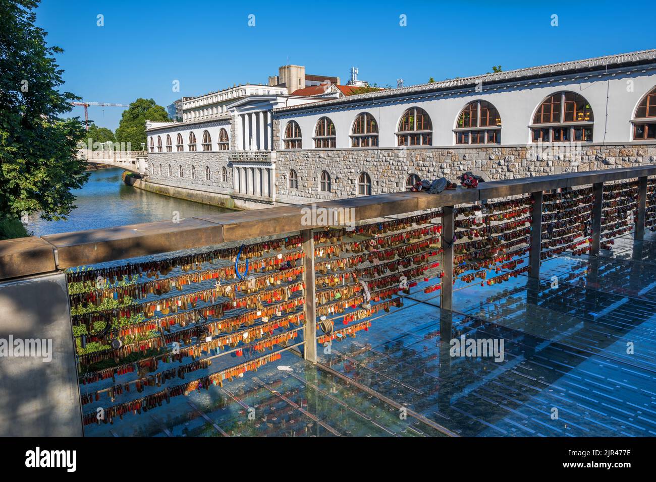 Ljubljana, Slovenia - July 13, 2022: Love padlocks on the Butchers Bridge (Slovene: Mesarski most) on river Ljubljanica and Plecnik Arcades, city land Stock Photo