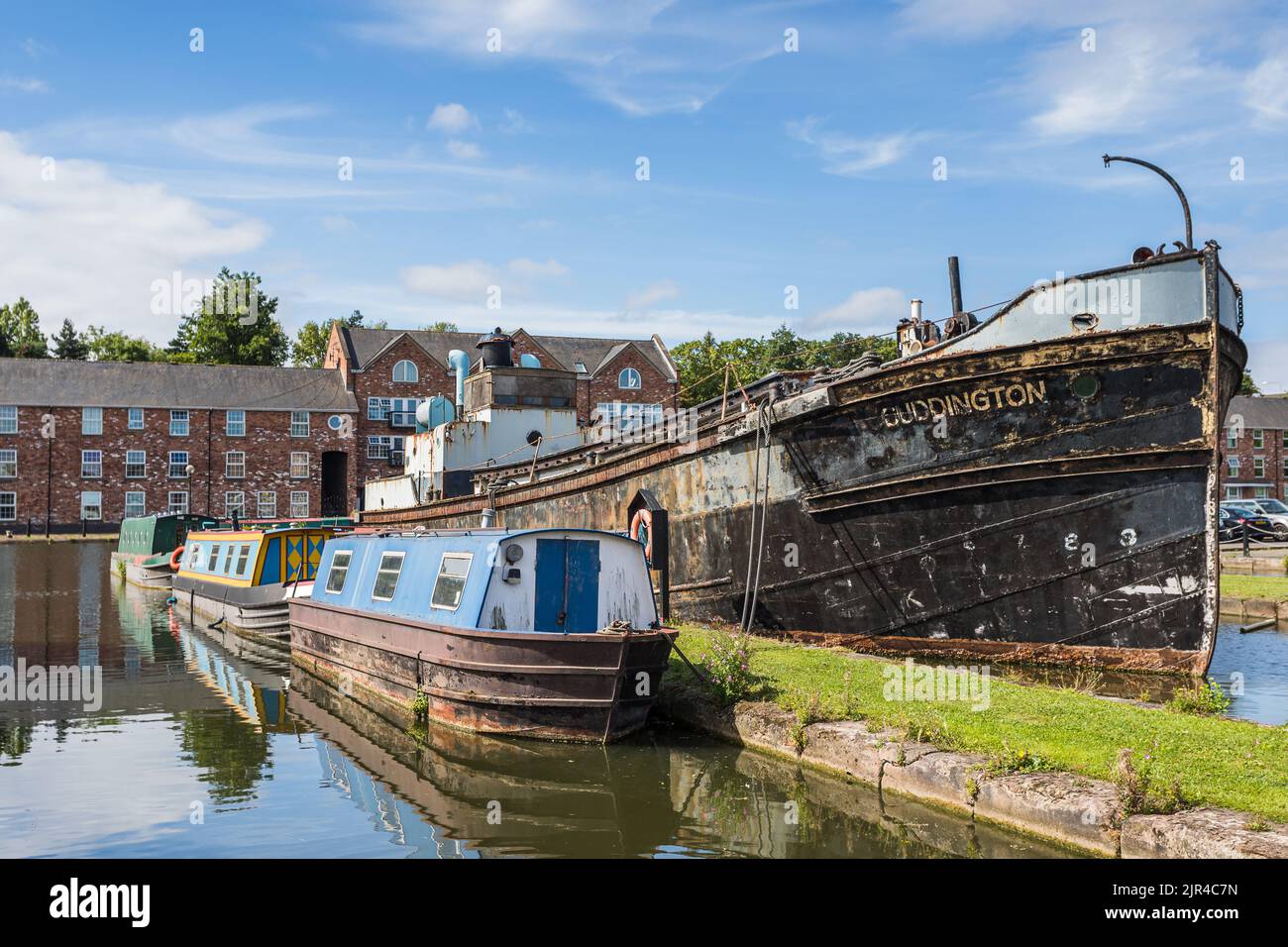 Varies canal barges of different ages and sizes pictured moored in Ellesmere Port, Cheshire in August 2022. Stock Photo