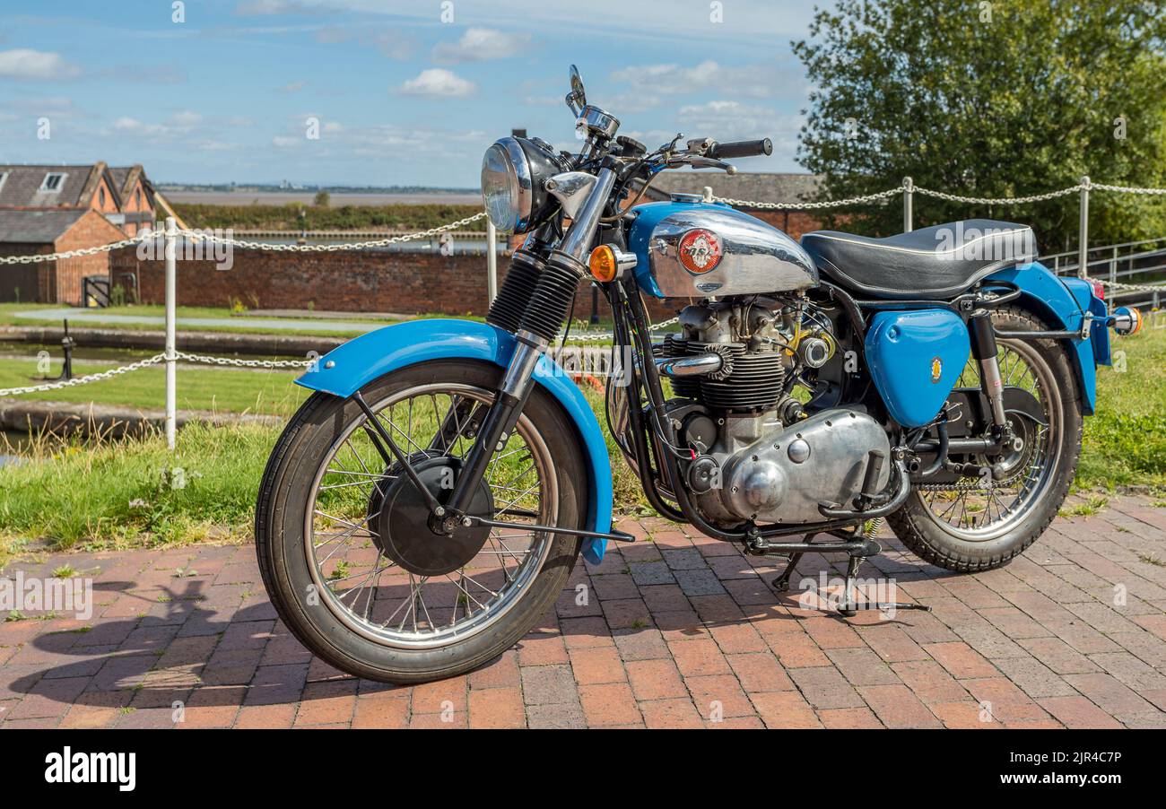 Blue BSA motorcycle parked on paving in Cheshire pictured in August 2022. Stock Photo