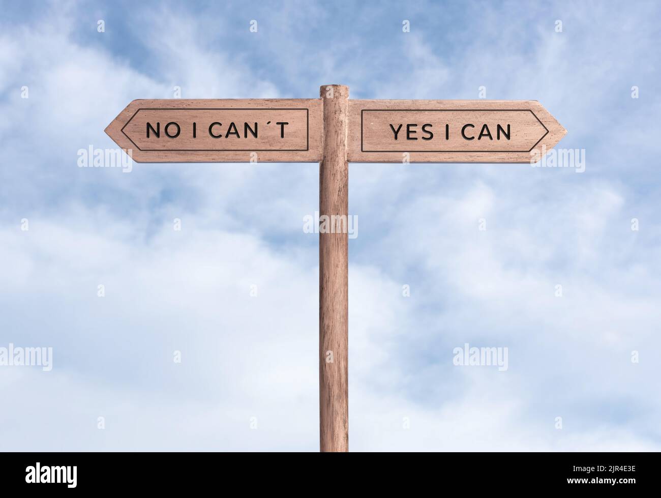 Yes I can concept or No I can not. Signpost with two messages on opposite way and sky background Stock Photo