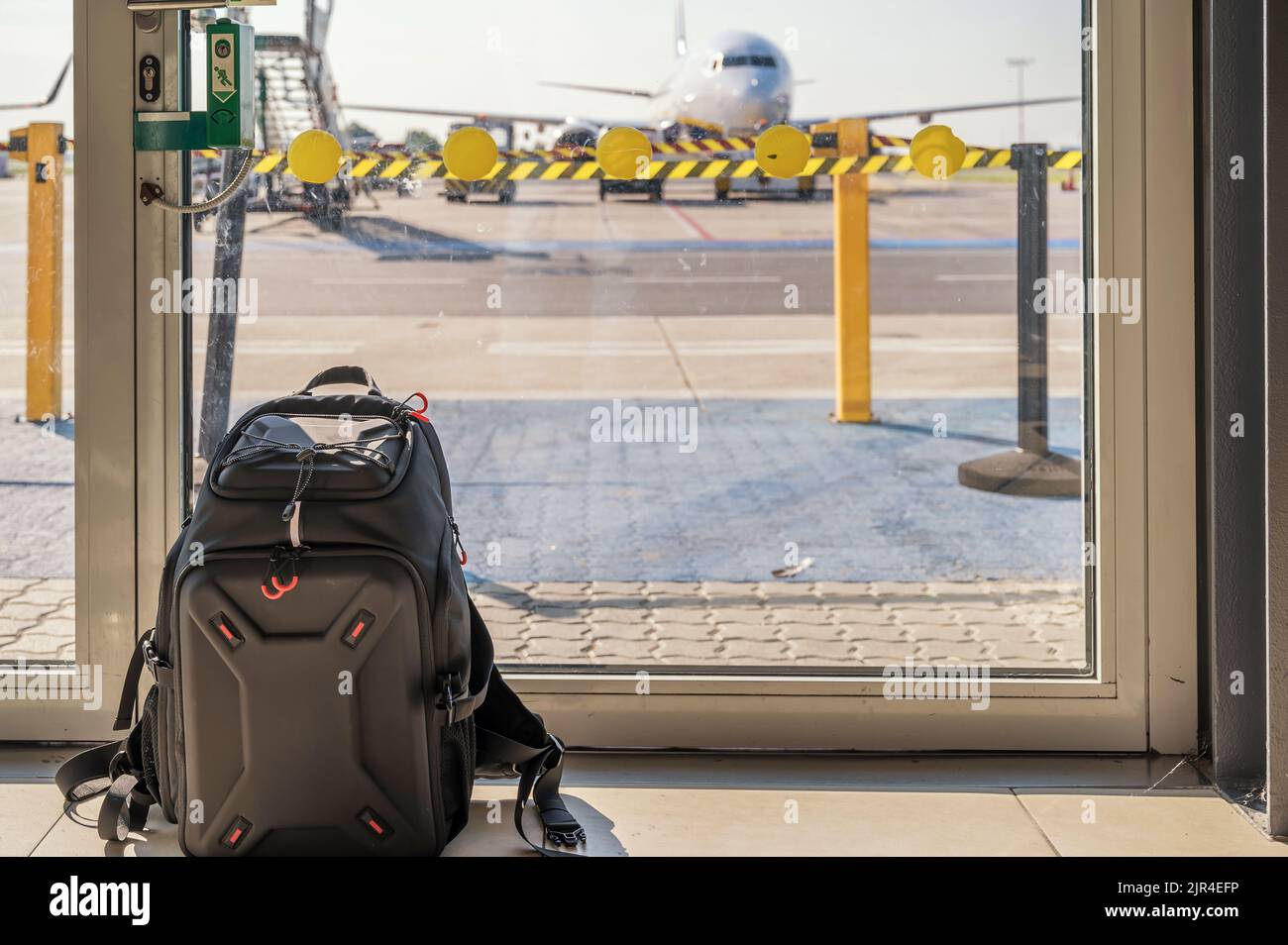 Hand luggage at the airport in front of an airplane as a symbol for baggage regulations Stock Photo