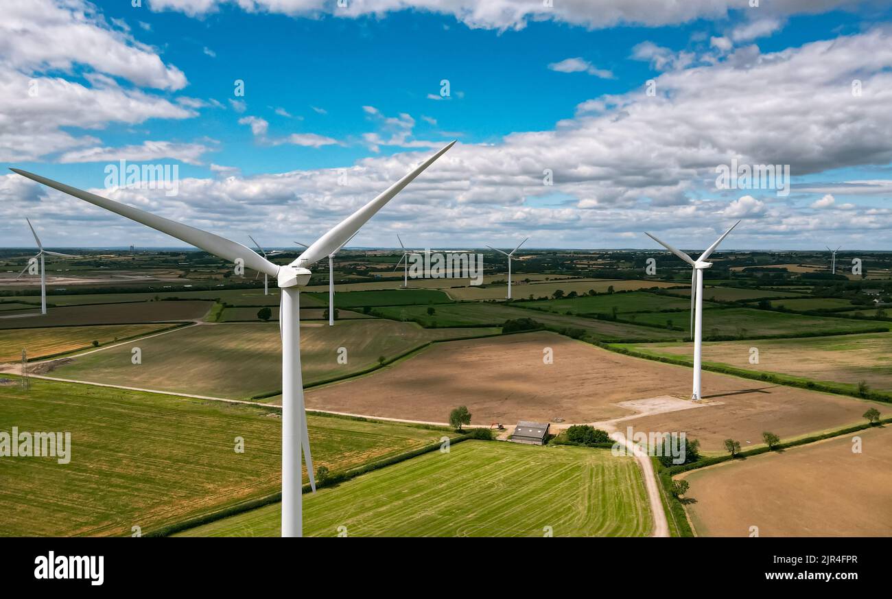 Wind Turbines Across Farmland with Blue Sky and Clouds Stock Photo - Alamy