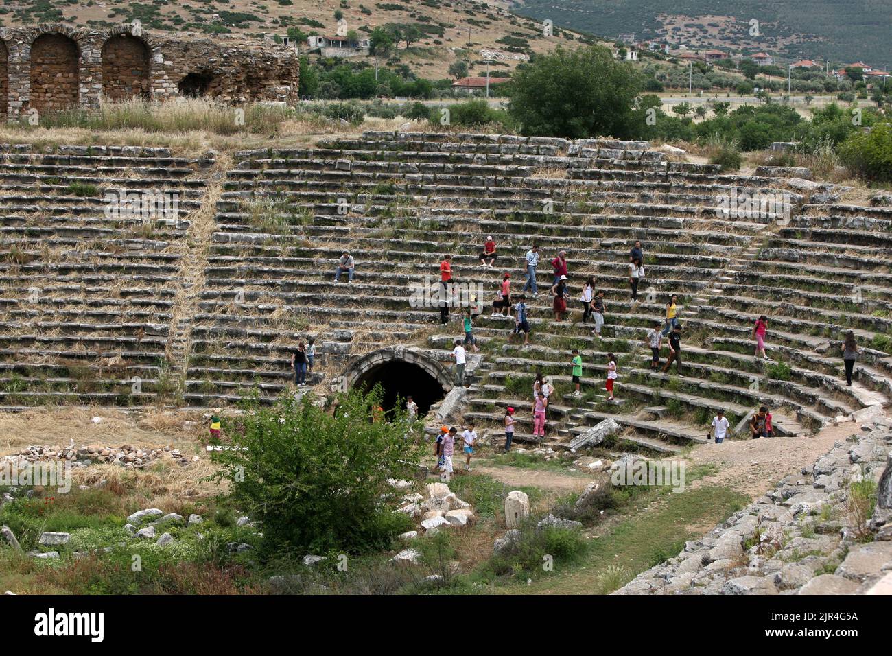 Visitors to the ancient site of Aphrodisias in Turkey climb amongst the ruins of the 30,000 seat stadium. Stock Photo