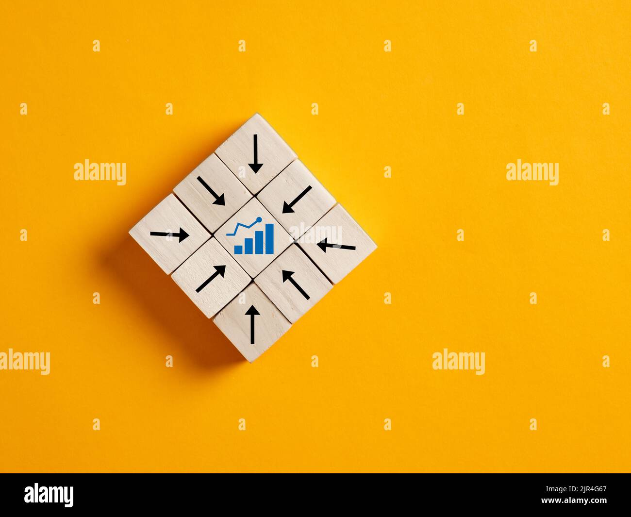 Arrows on wooden blocks points the ascending growth chart. Financial growth in business. Increase revenue, profit, income. Developing market performan Stock Photo