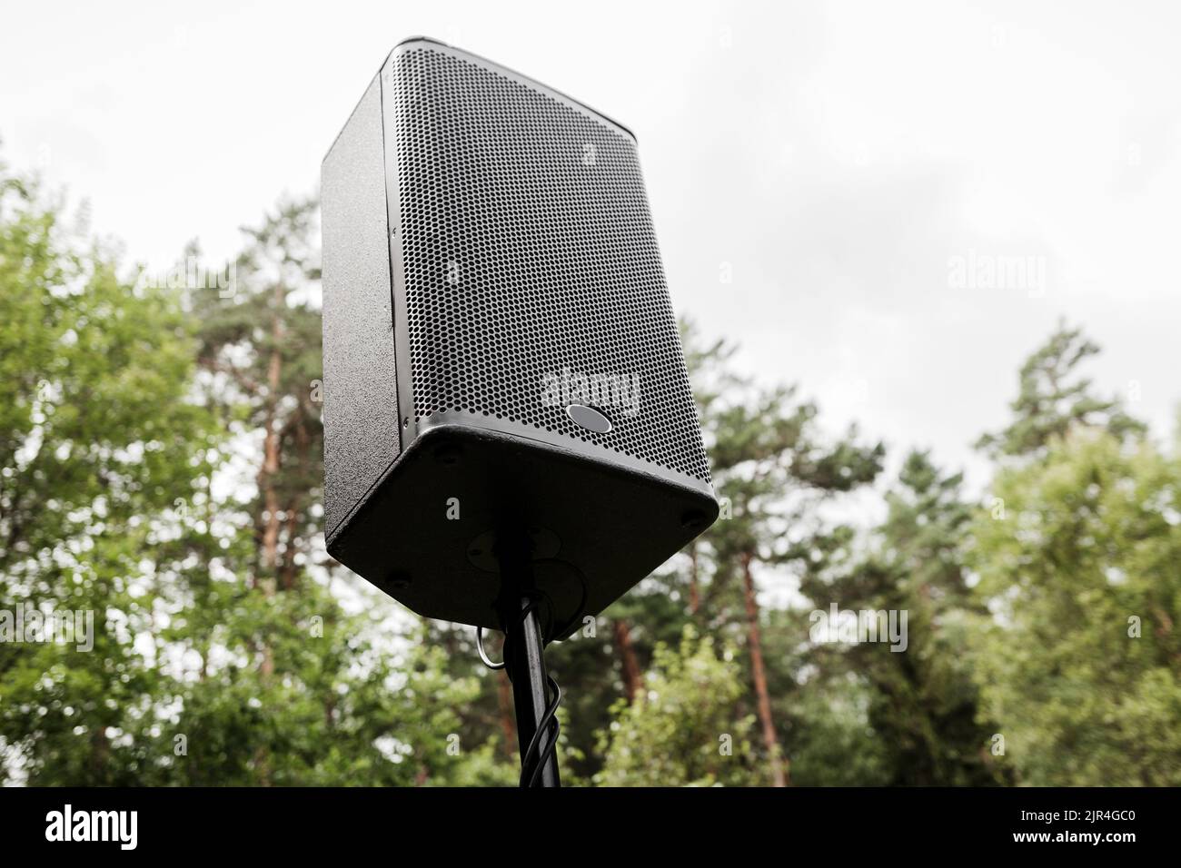 Black big speaker on stand outdoor. Large audio speaker and equipment