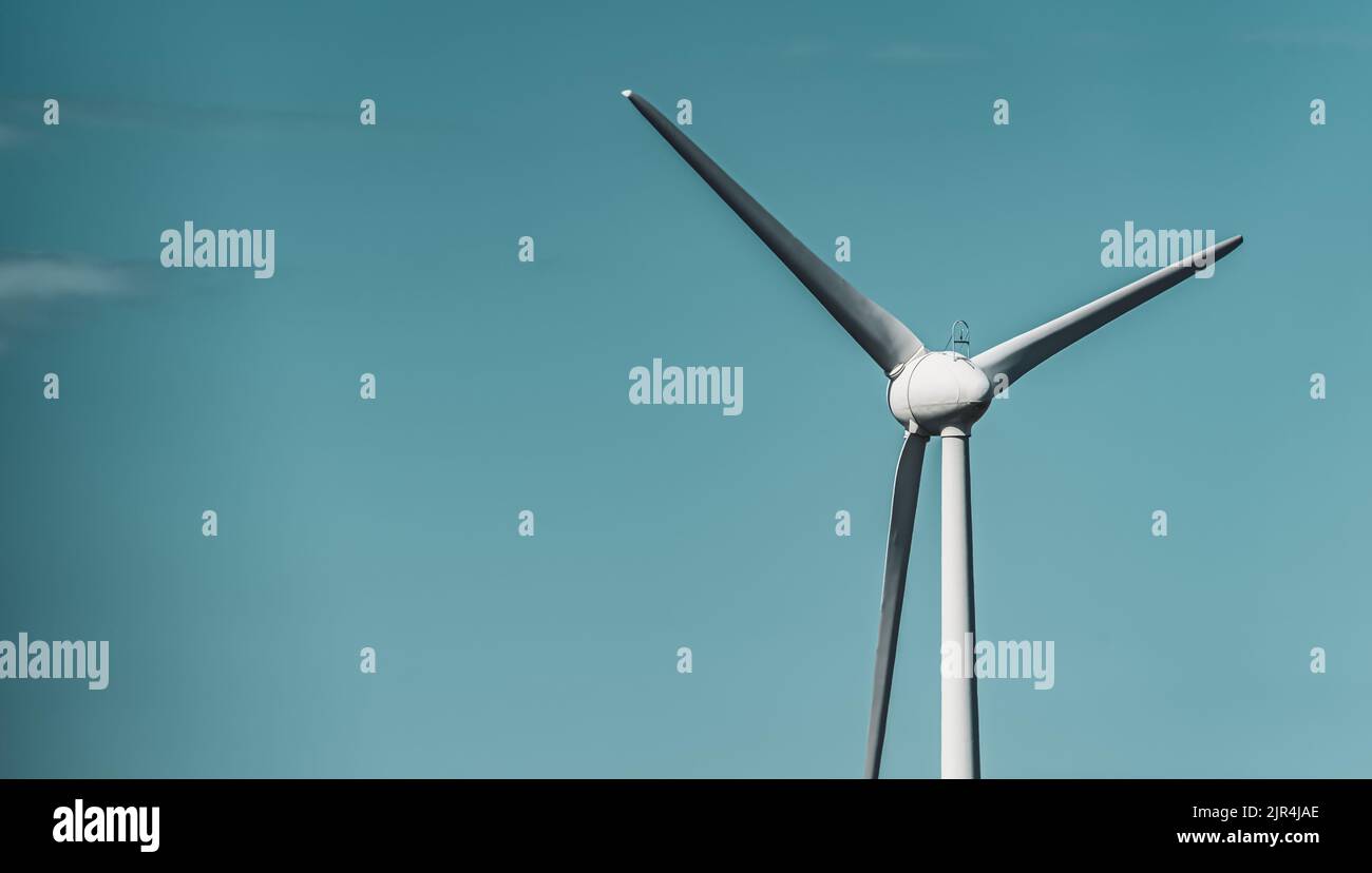 Wind turbine on blue sky Stock Photo - Alamy