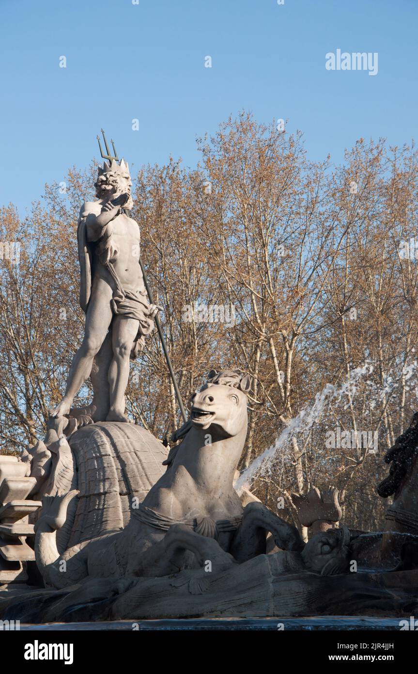A vertical shot of the fountain devoted to Neptune in a park in Madrid