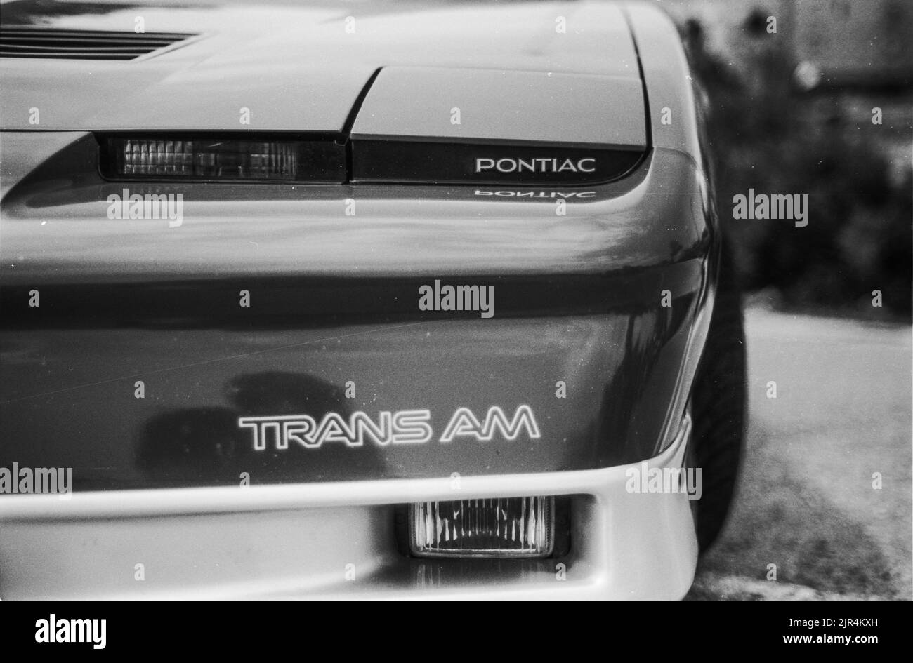 A closeup grayscale shot of Pontiac Firebird Trans AM car Stock Photo