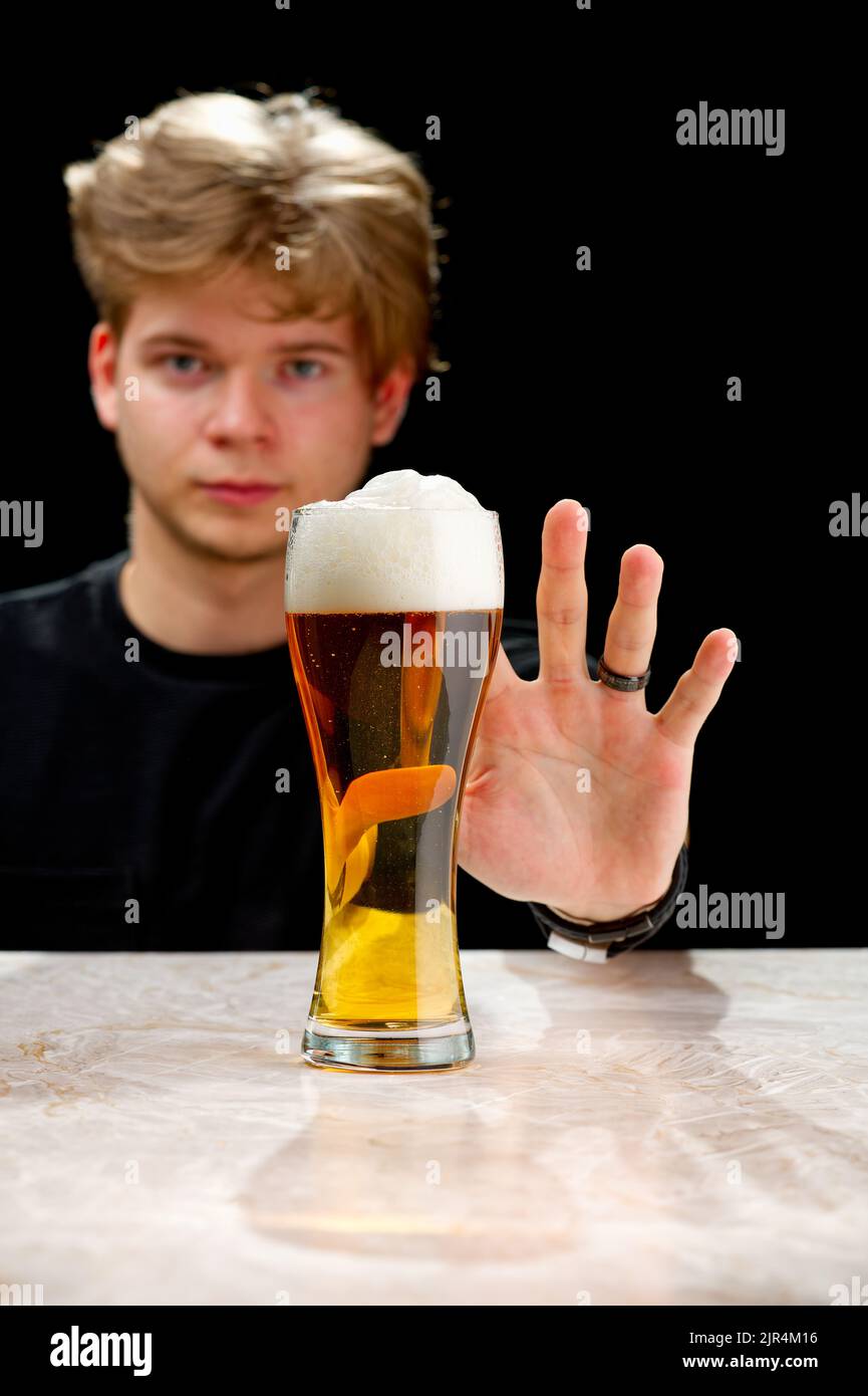 No alcohol. Young man refuses to beer. Young man stop drinking. alcohol addiction Stock Photo