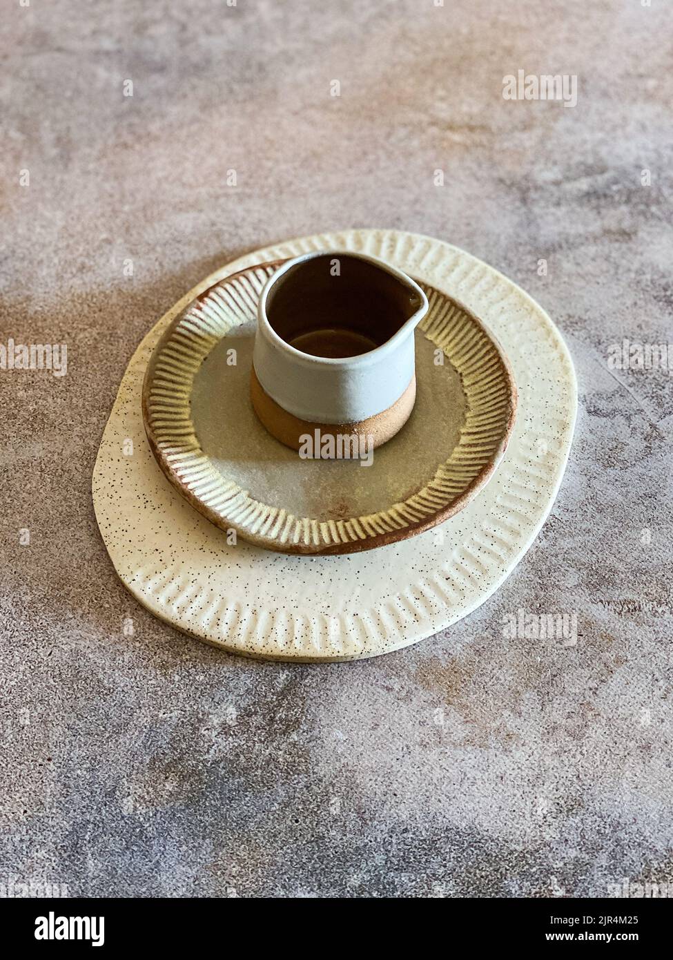 HandmadeCeramic Milk Jug and Plates on stone background Stock Photo Alamy