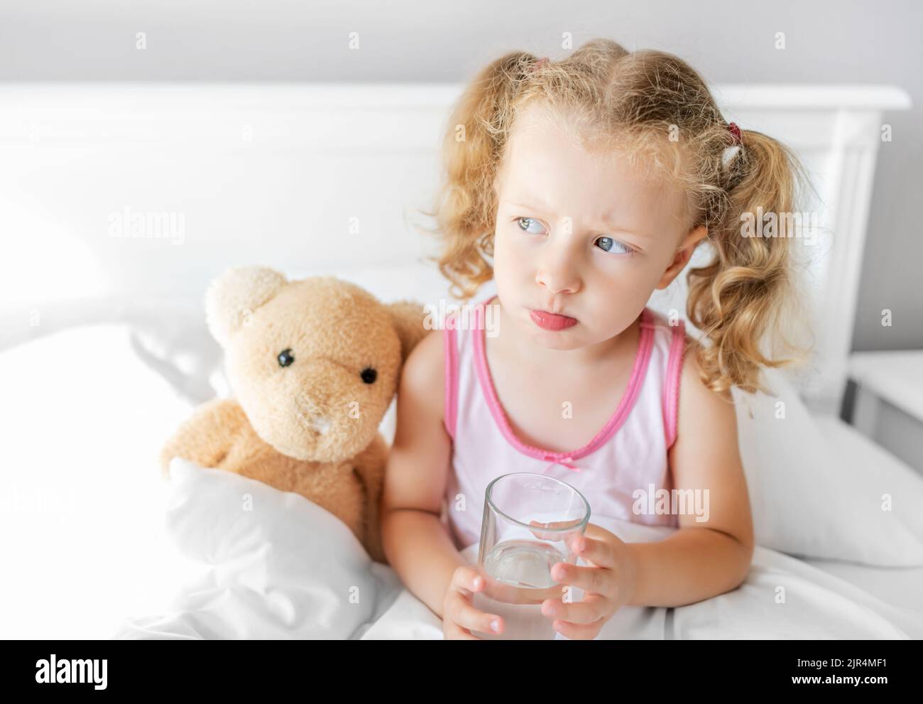 The child is drinking water in the bed Stock Photo Alamy