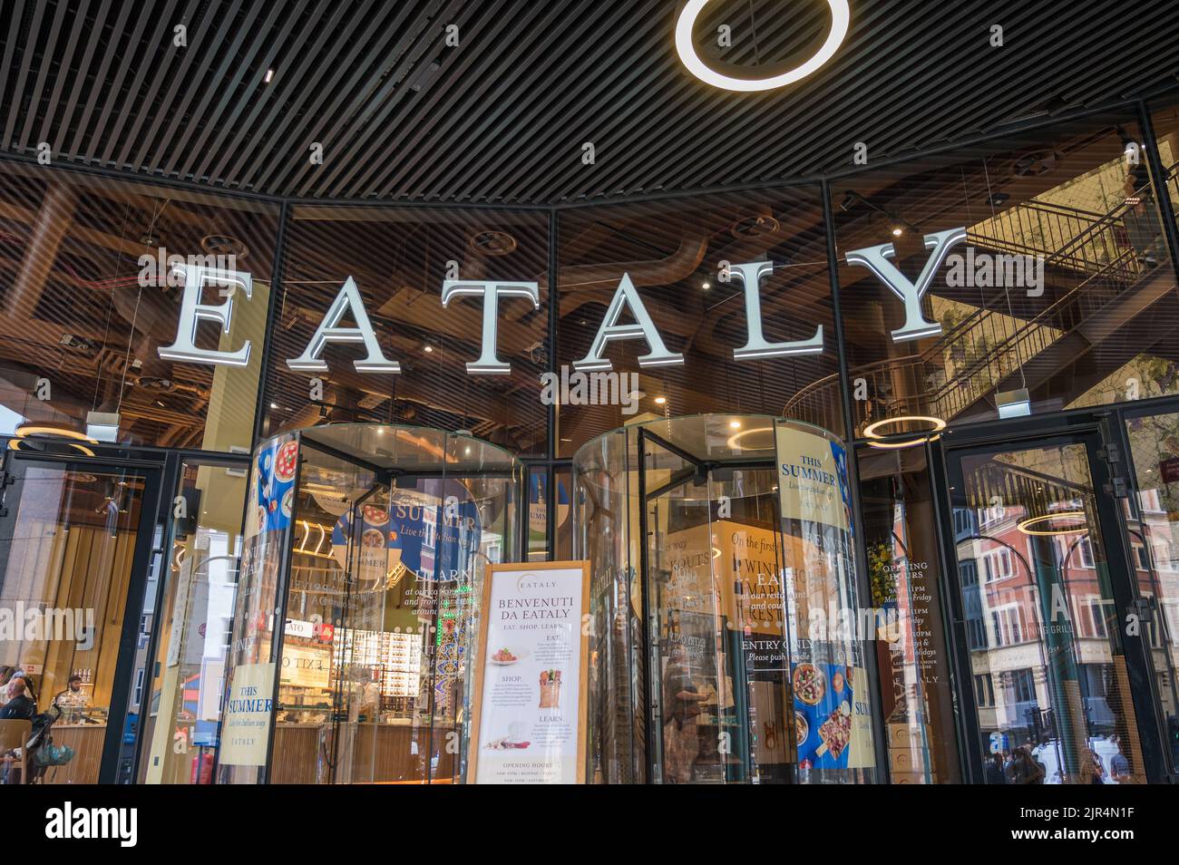 Main entrance and brightly lit interior to Eataly Italian restaurants, bars  and food market. Bishopsgate, London, England, UK Stock Photo