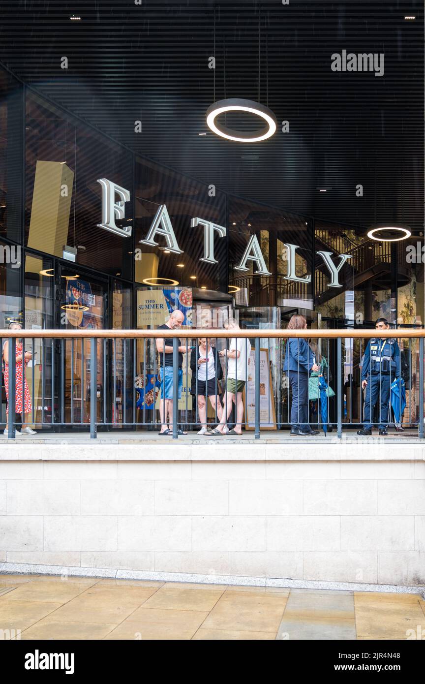 People grouped at the entrance to Eataly Italian restaurant, bar and food market. Bishopsgate, London, England, UK Stock Photo