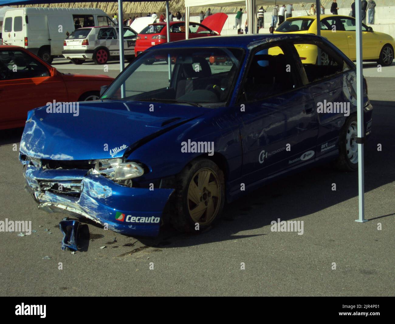 A crashed blue Opel Astra GSI parked on the street Stock Photo