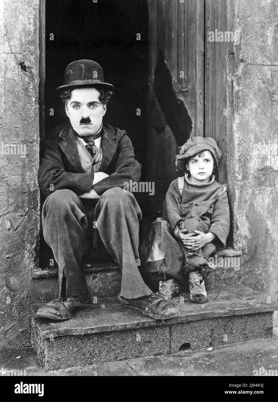 Charlie Chaplin - The Kid - a 1921 American silent comedy-drama film written, produced, directed by and starring Charlie Chaplin, and features Jackie Coogan as his foundling baby, adopted son and sidekick. Stock Photo