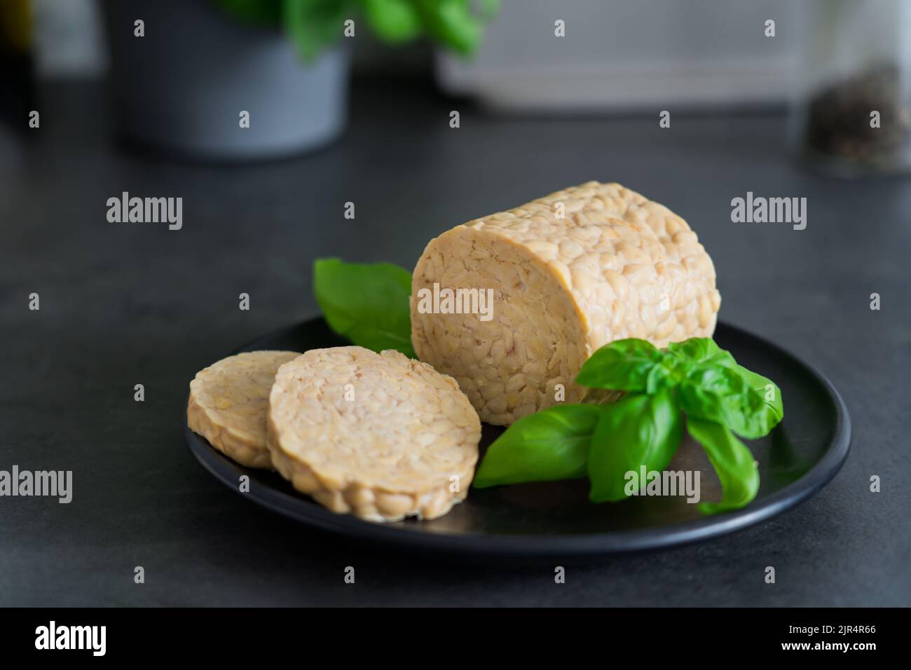 Raw Tempeh or Tempe, made of fermented soybean seeds on kitchen table