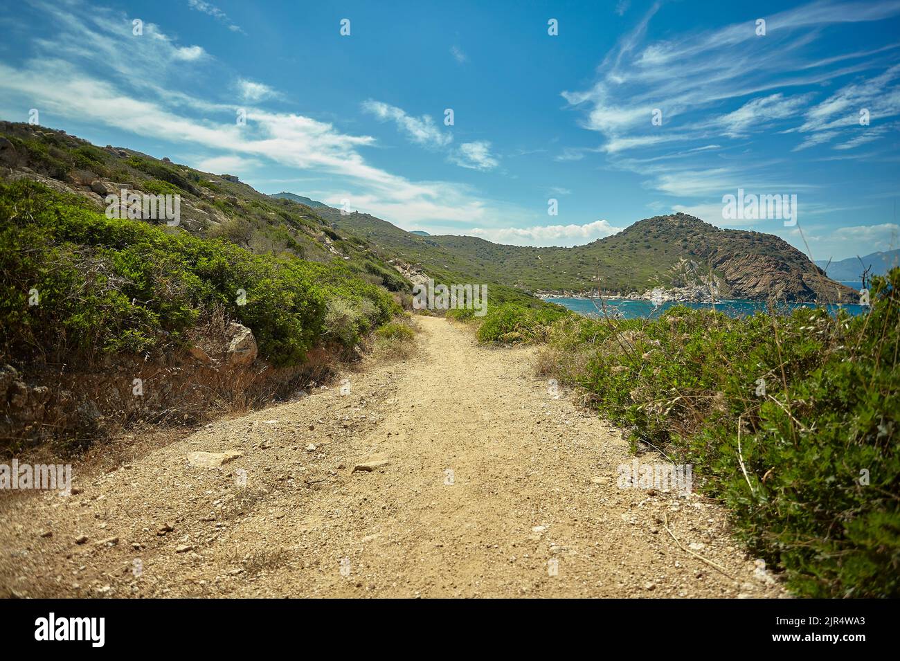 Small dirt path that runs along the coast of an area of southern Sardinia  with a precipice on the side of the sea Stock Photo - Alamy