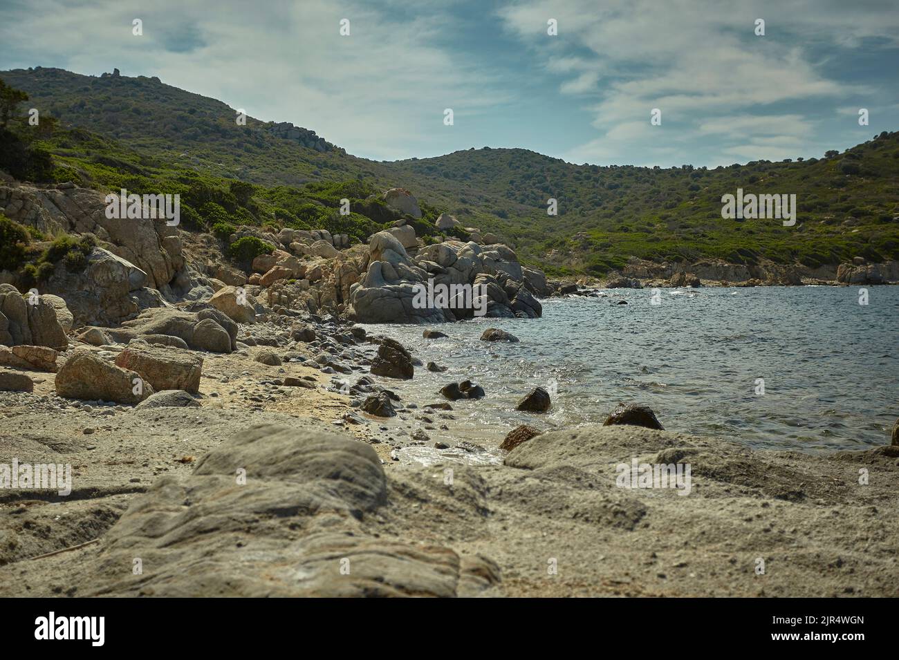 Mediterranean Rocks Jagged rocks with some green hills that merge into the Mediterranean ...