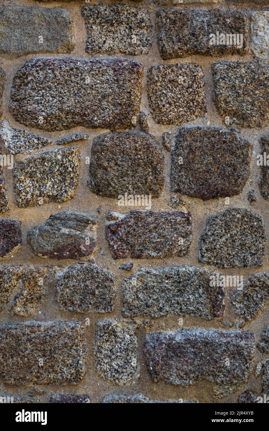 Roman defensive stone wall texture with irregular polygonal blocks built in ancient times. Vertical background with copy space Stock Photo