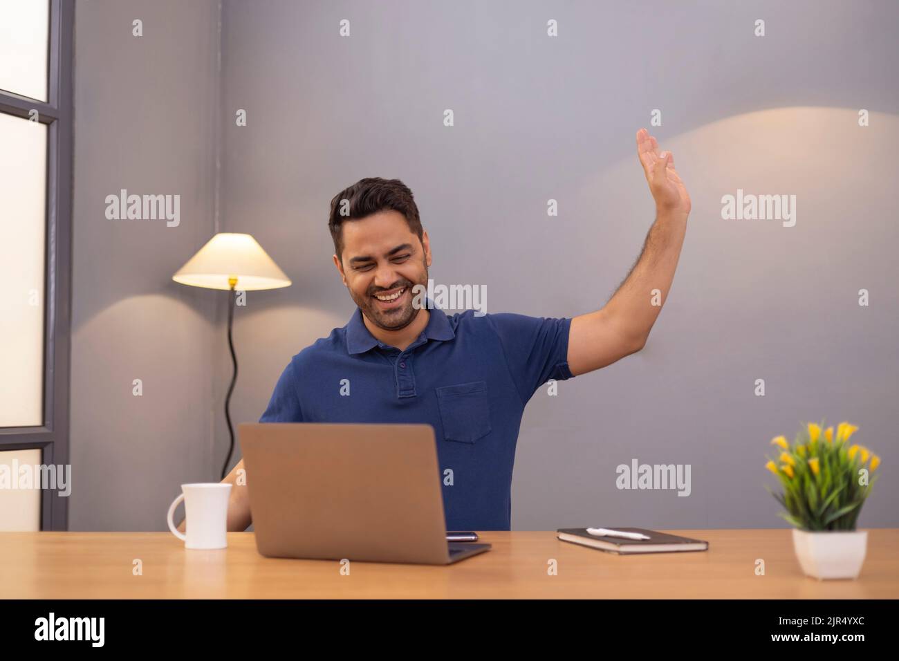 Male freelancer using laptop At Home Office Stock Photo