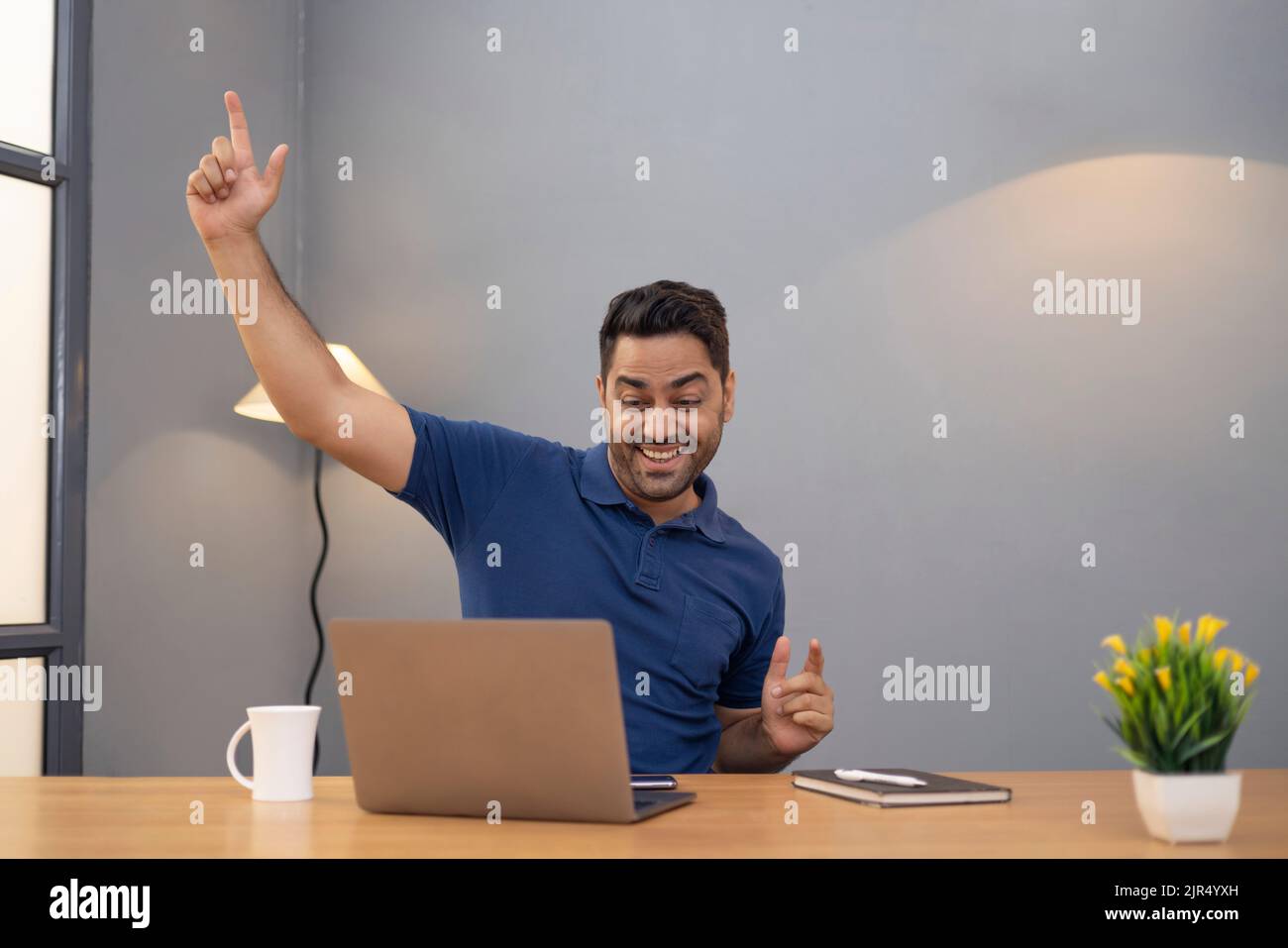 Male freelancer using laptop At Home Office Stock Photo