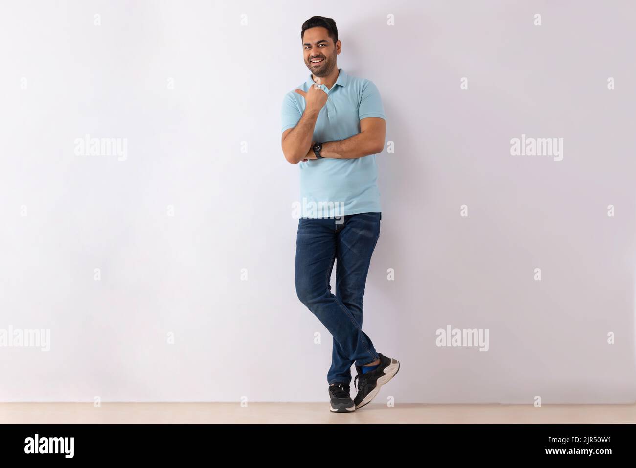 Portrait of a young man standing against white background Stock Photo ...
