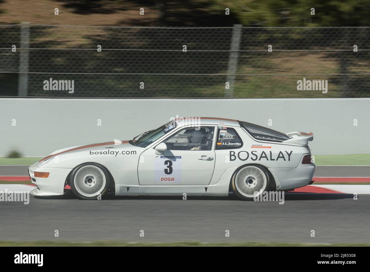 A white classic Porsche 911 car racing in a track in Barcelona, Spain Stock Photo