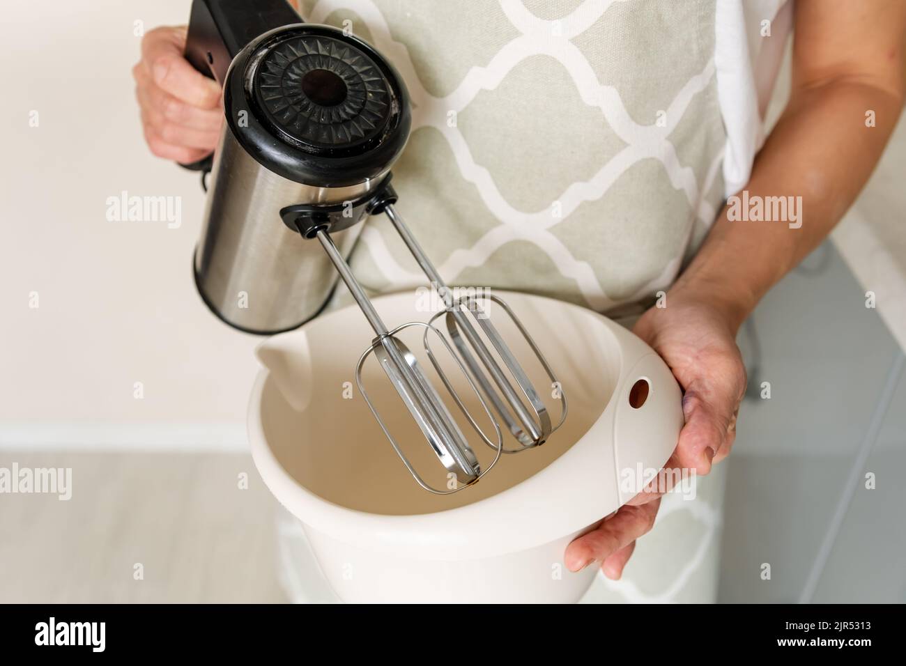 Female cook mixes ingredients in hi-res stock photography and images ...