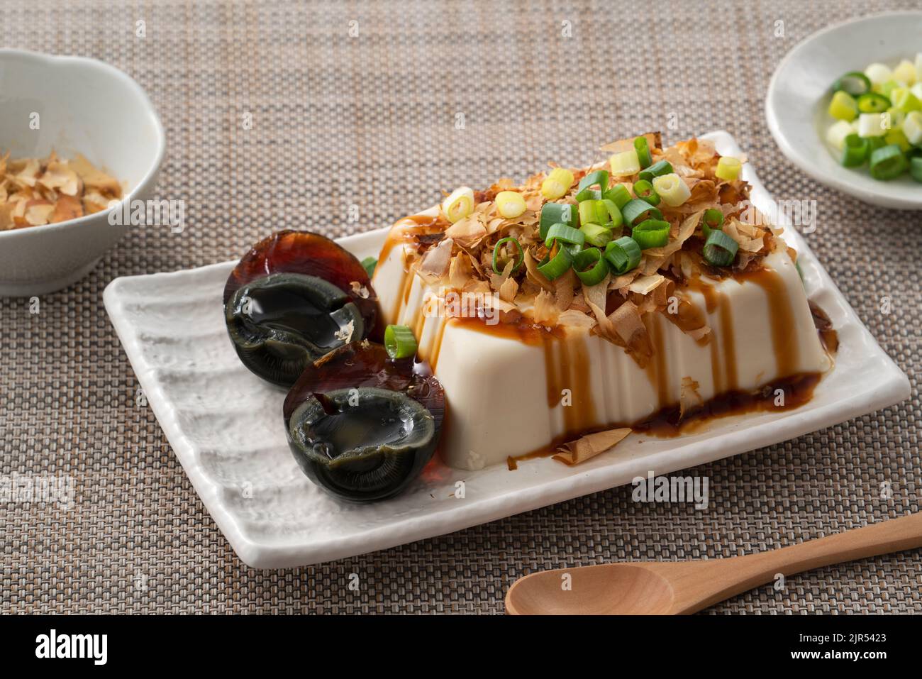 Delicious Chilled tofu and century egg food with soy sauce and bonito