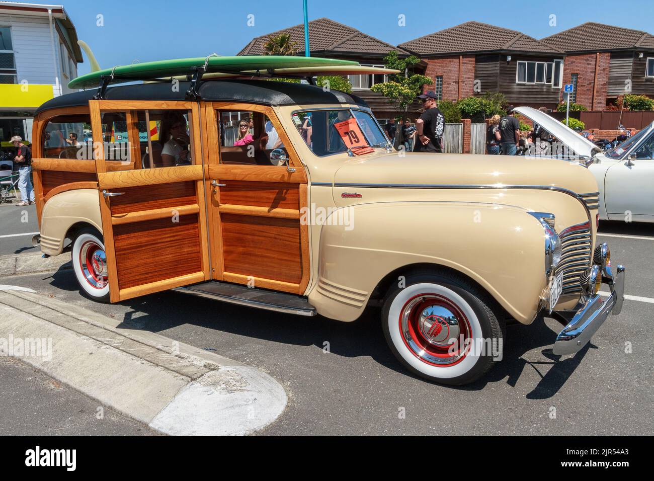 A 1941 Plymouth Deluxe 'Woody' wagon with surfboards on the roof rack Stock Photo