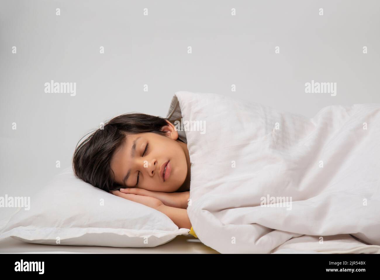 Portrait of a cute boy sleeping on bed Stock Photo - Alamy