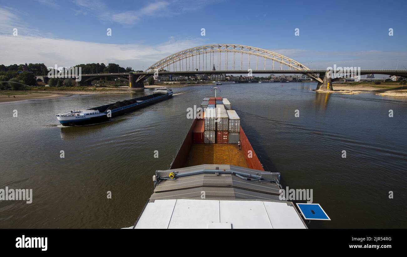 2022-08-22 10:50:46 NIJMEGEN - Containers on board an inland vessel on the river Waal near the Waalbrug near Nijmegen. Due to the low water levels in the Rhine, inland vessels can carry less cargo. ANP VINCENT JANNINK netherlands out - belgium out Stock Photo