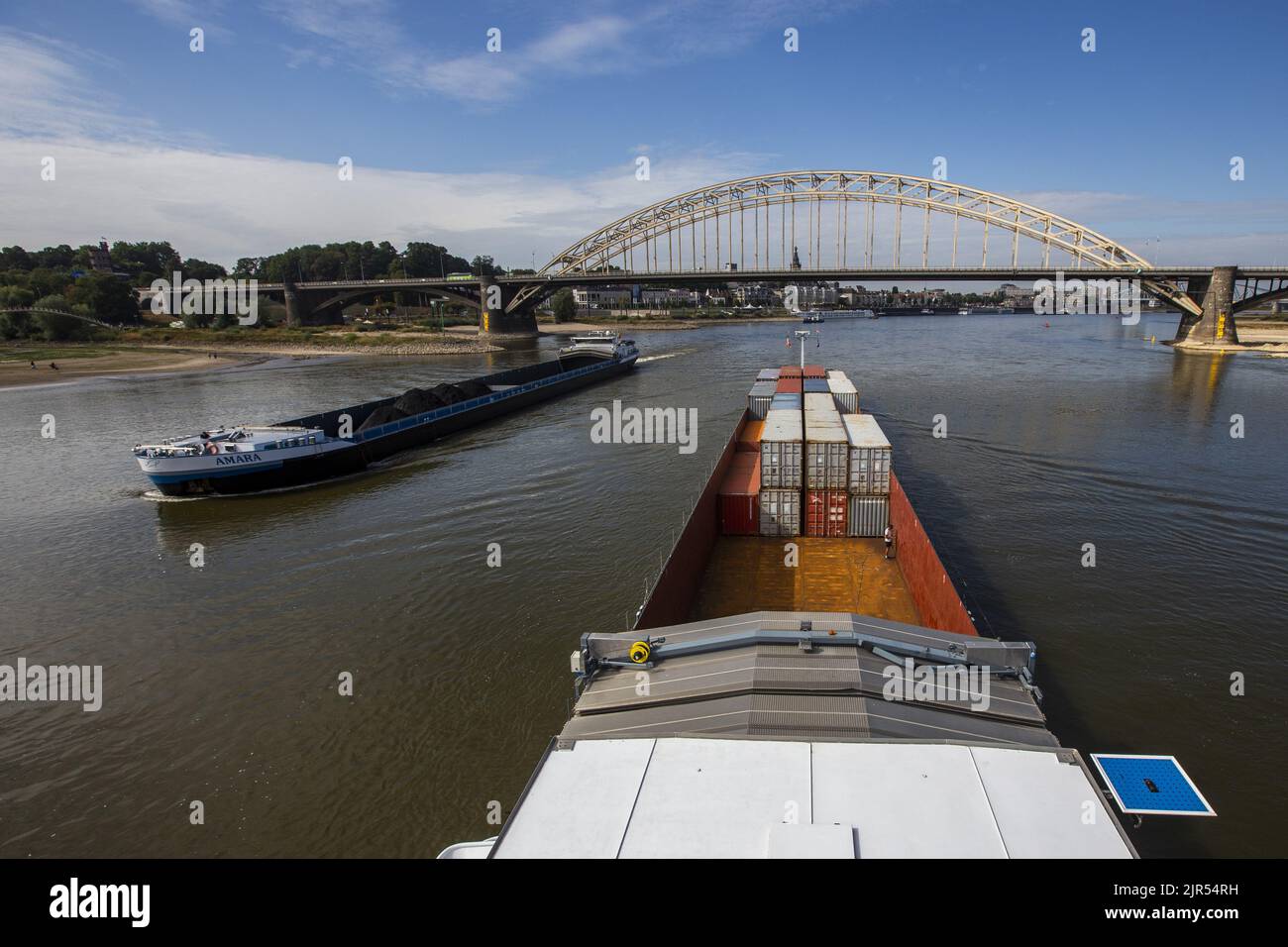 2022-08-22 10:50:48 NIJMEGEN - Containers on board an inland vessel on the river Waal near the Waalbrug near Nijmegen. Due to the low water levels in the Rhine, inland vessels can carry less cargo. ANP VINCENT JANNINK netherlands out - belgium out Stock Photo