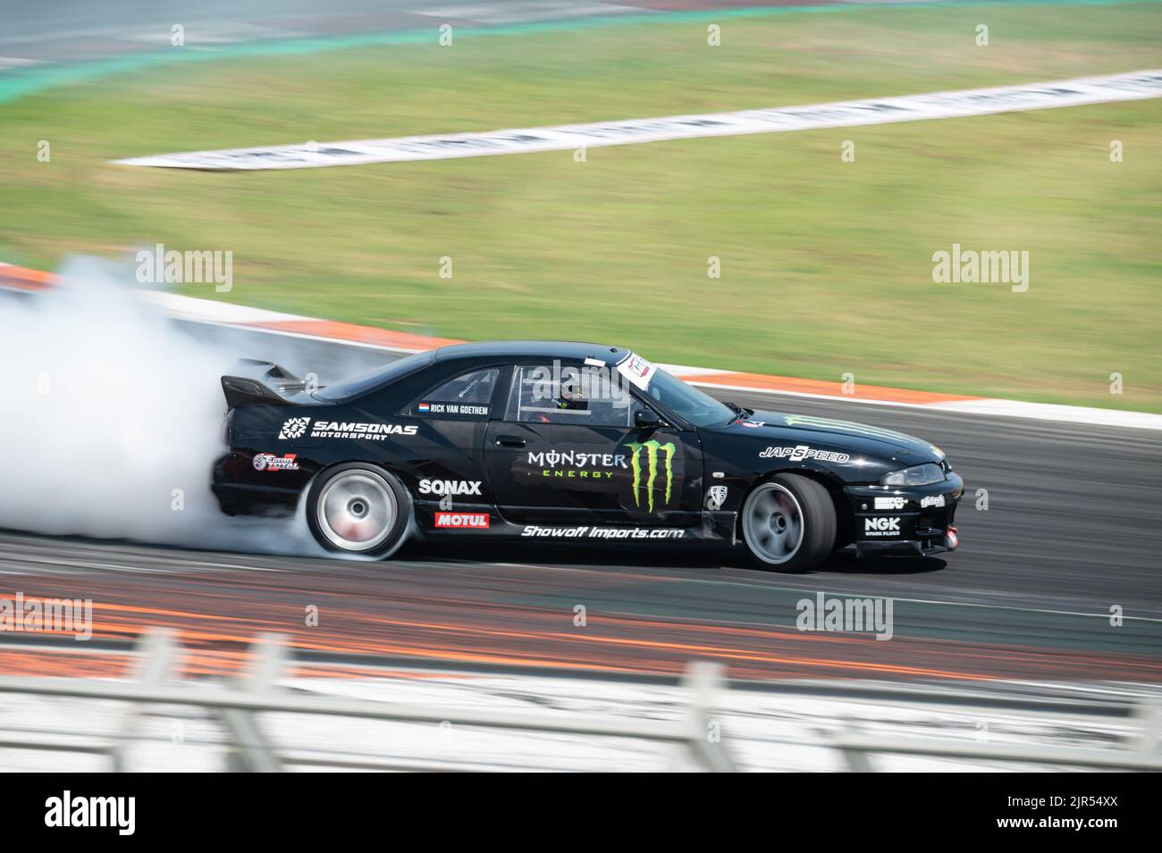 A Nissan Skyline GT-R R33 skidding on the race track Stock Photo