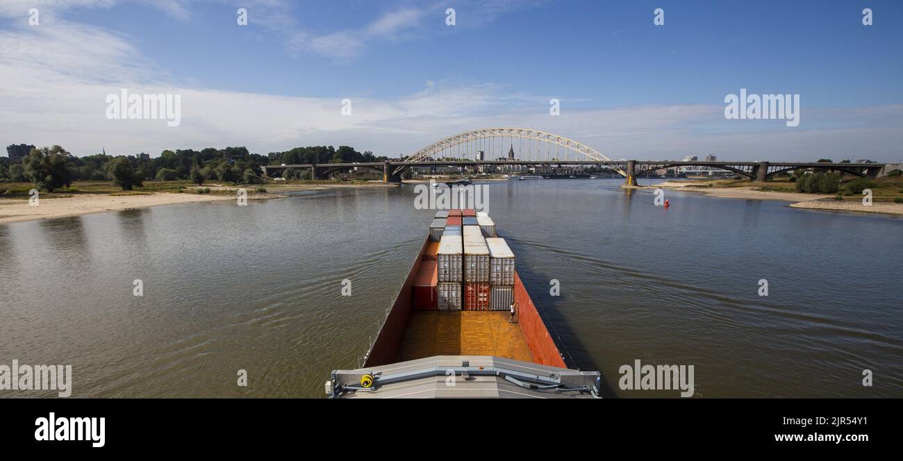 2022-08-22 10:49:57 NIJMEGEN - Containers on board an inland vessel on the river Waal near the Waalbrug near Nijmegen. Due to the low water levels in the Rhine, inland vessels can carry less cargo. ANP VINCENT JANNINK netherlands out - belgium out Stock Photo