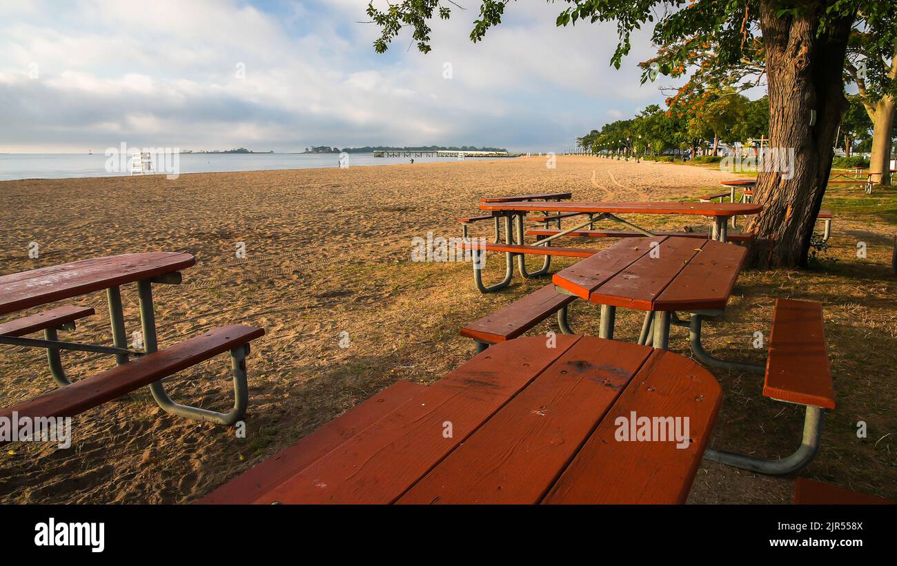 NORWALK, CT USA - AUGUST 21, 2022: Beautiful early morning on Calf Pasture Beach wit empty tables Stock Photo