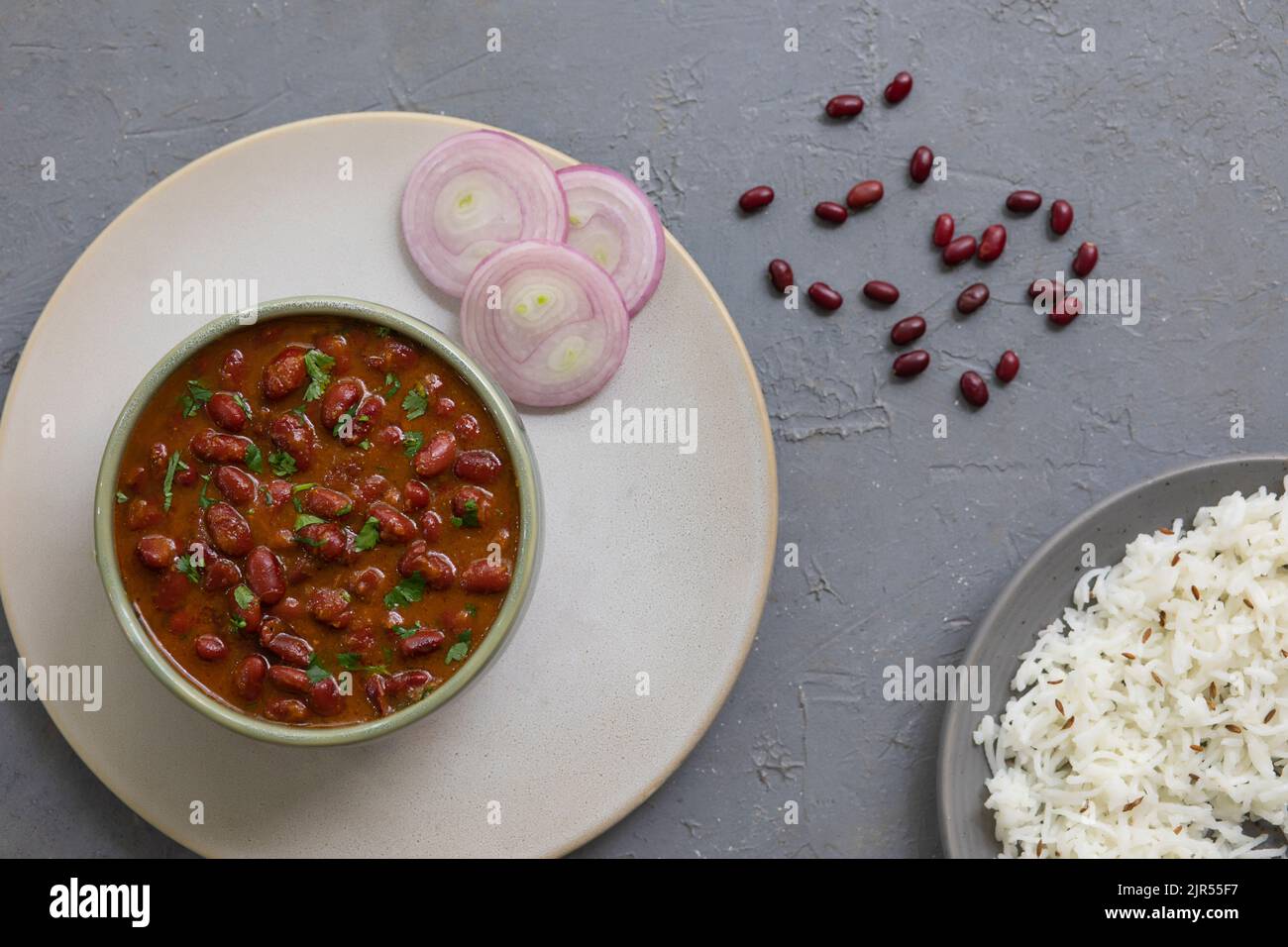 GARNISHED RAJMA CURRY SERVED IN A PLATE ALONG WITH JEERA RICE Stock