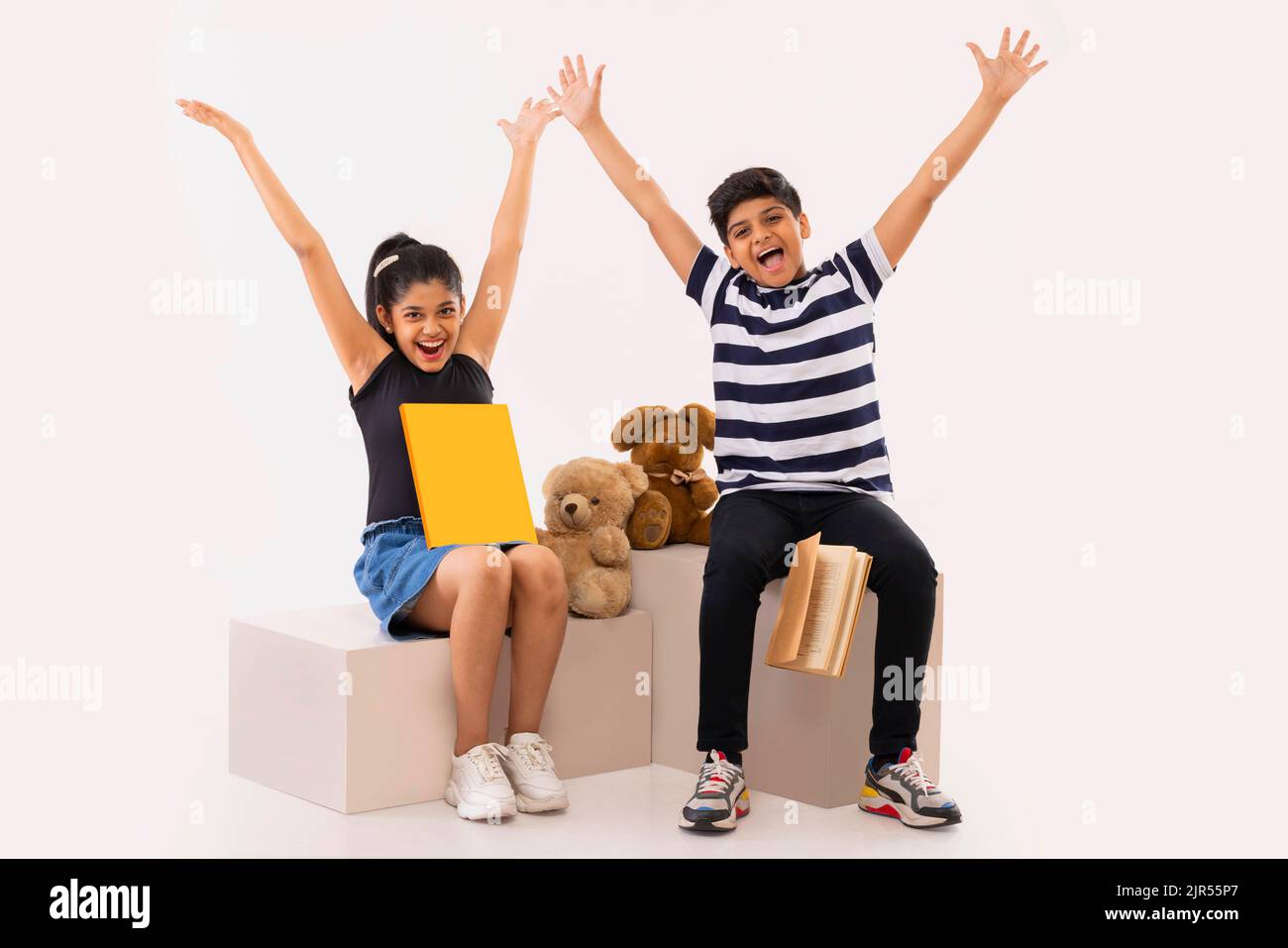 Portrait of two children having fun against white background Stock Photo