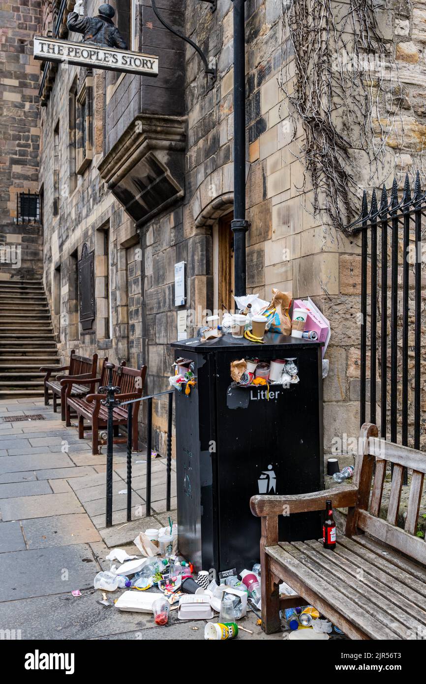 Overflowing garbage can outside house hires stock photography and