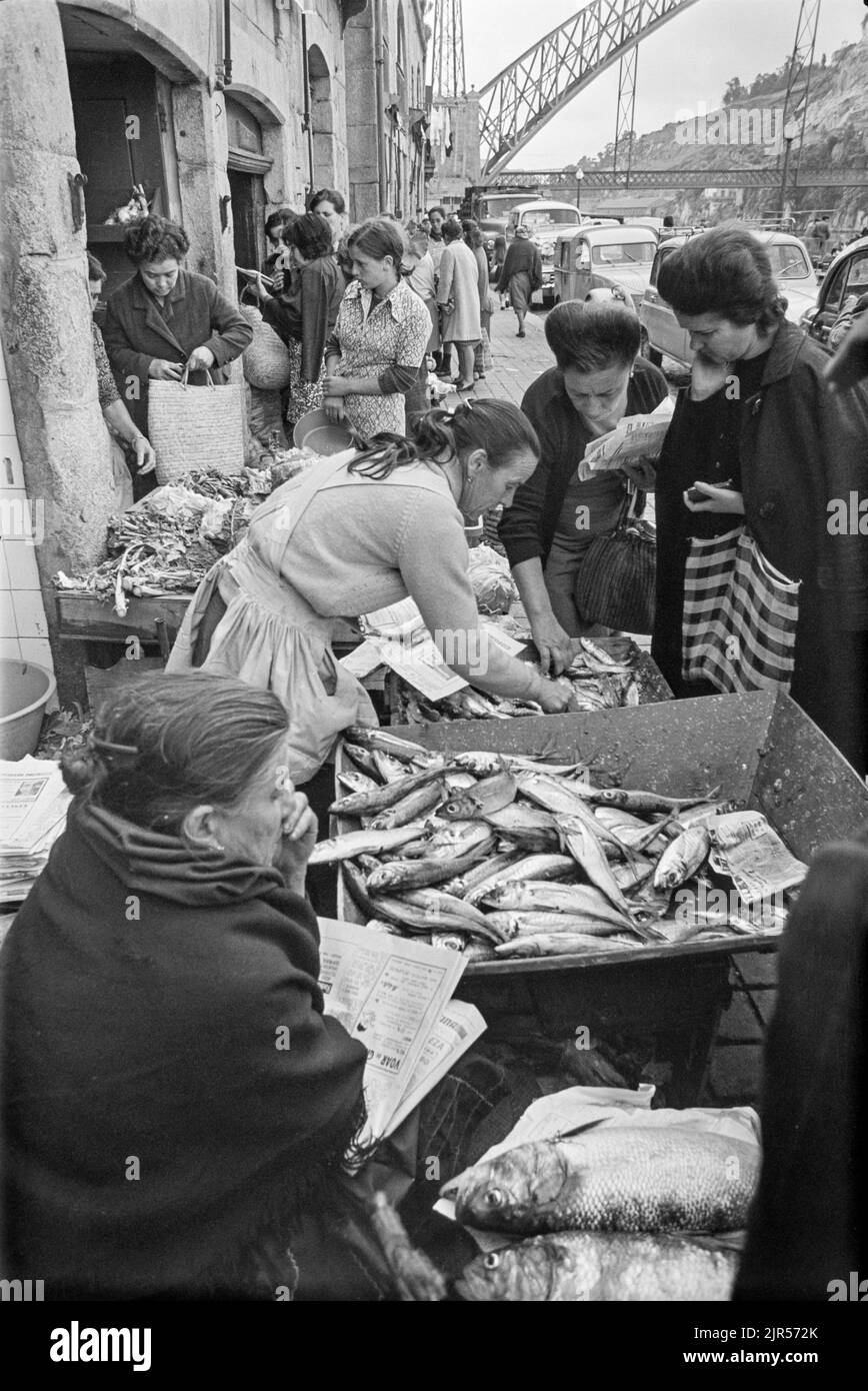 PORTUGAL - PORTO -  1970. Women buying fish at a market by the river in the Ribeira district of Porto, Northern Portugal.  Copyright Photograph: by Pe Stock Photo