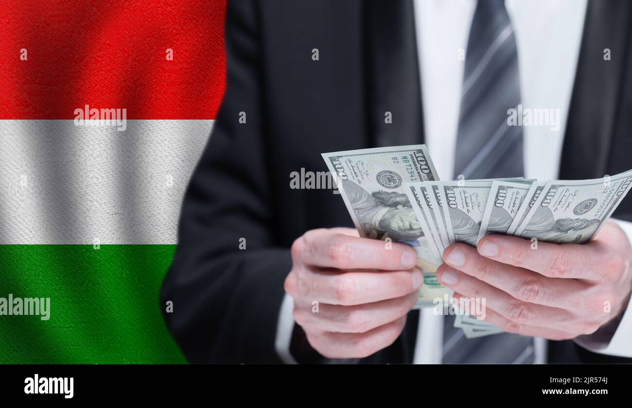 Hands holding dollar money on flag of Hungary Stock Photo