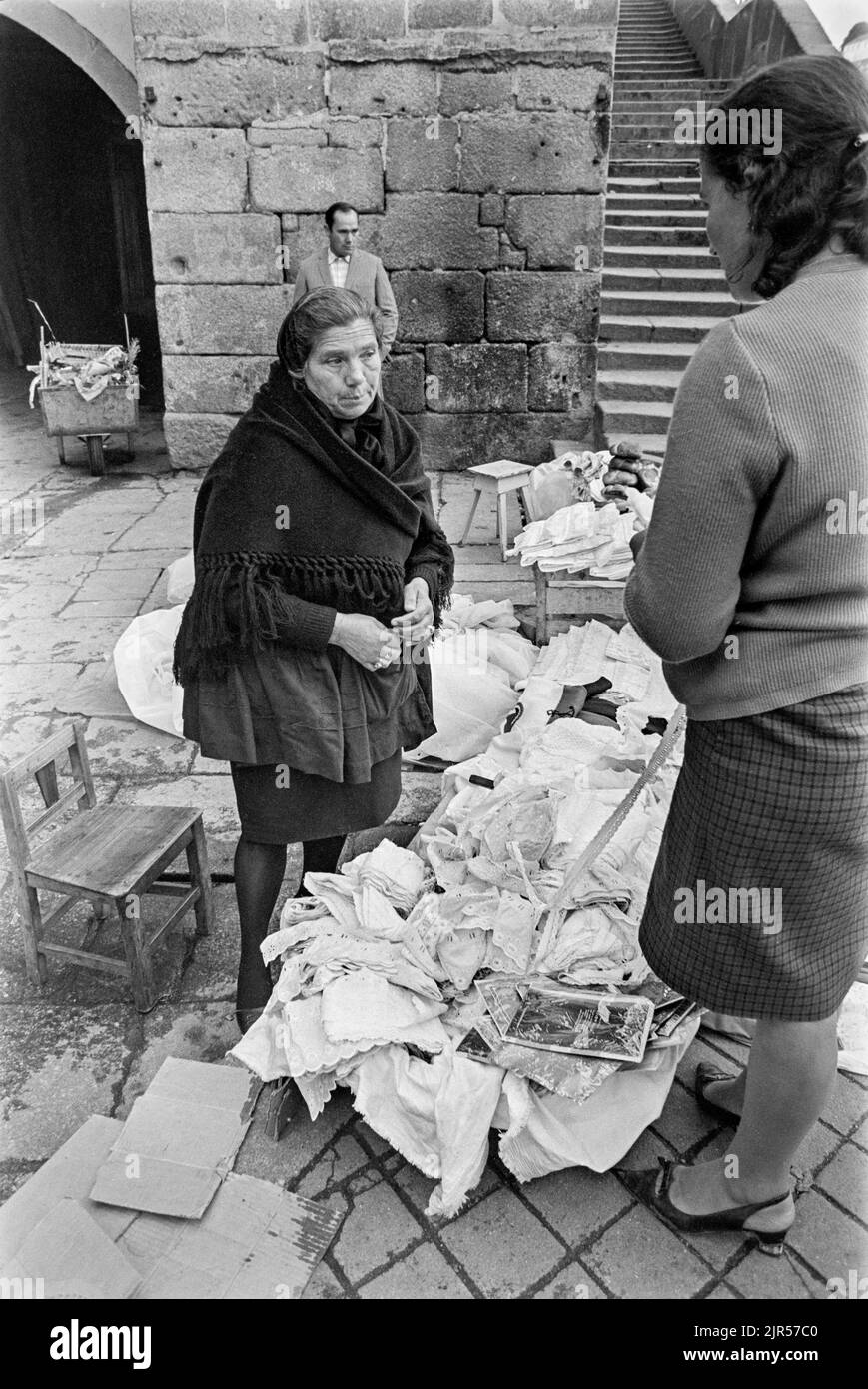 PORTUGAL - PORTO -  1970. Women selling lace and other items at a market by the river in the Ribeira district of Porto, Northern Portugal.  Copyright Stock Photo