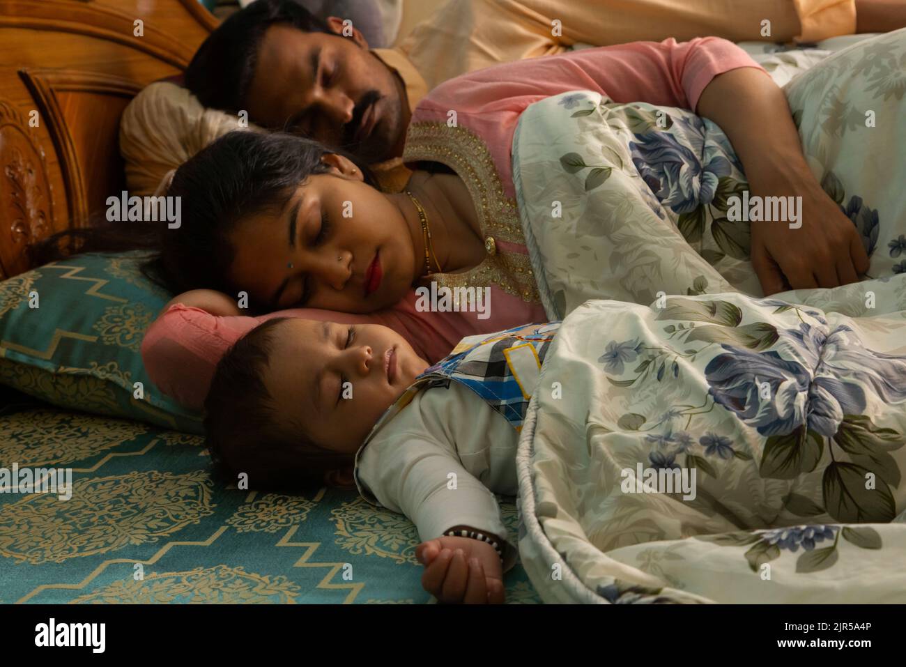 Portrait of little baby sleeping with parent on bed Stock Photo Alamy