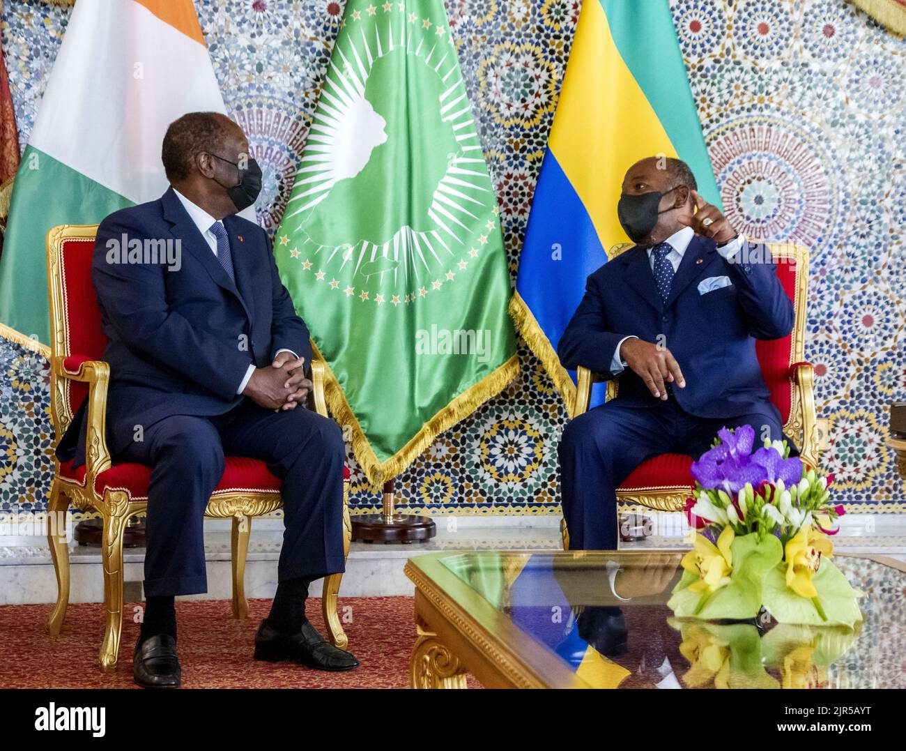 Ivorian President Alassane Ouattara (L) is received by his Gabonese counterpart Ali Bongo Ondimba (R) at the Gabonese presidency during a friendship and working visit by the Ivory Coast president to Libreville on January 17, 2022. Stock Photo