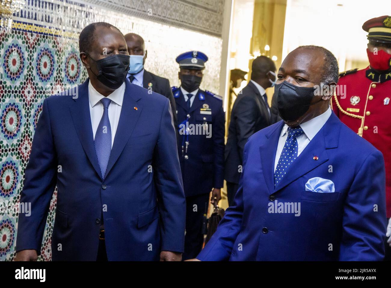 Ivorian President Alassane Ouattara (L) is received by his Gabonese counterpart Ali Bongo Ondimba (R) at the Gabonese presidency during a friendship and working visit by the Ivory Coast president to Libreville on January 17, 2022. Stock Photo