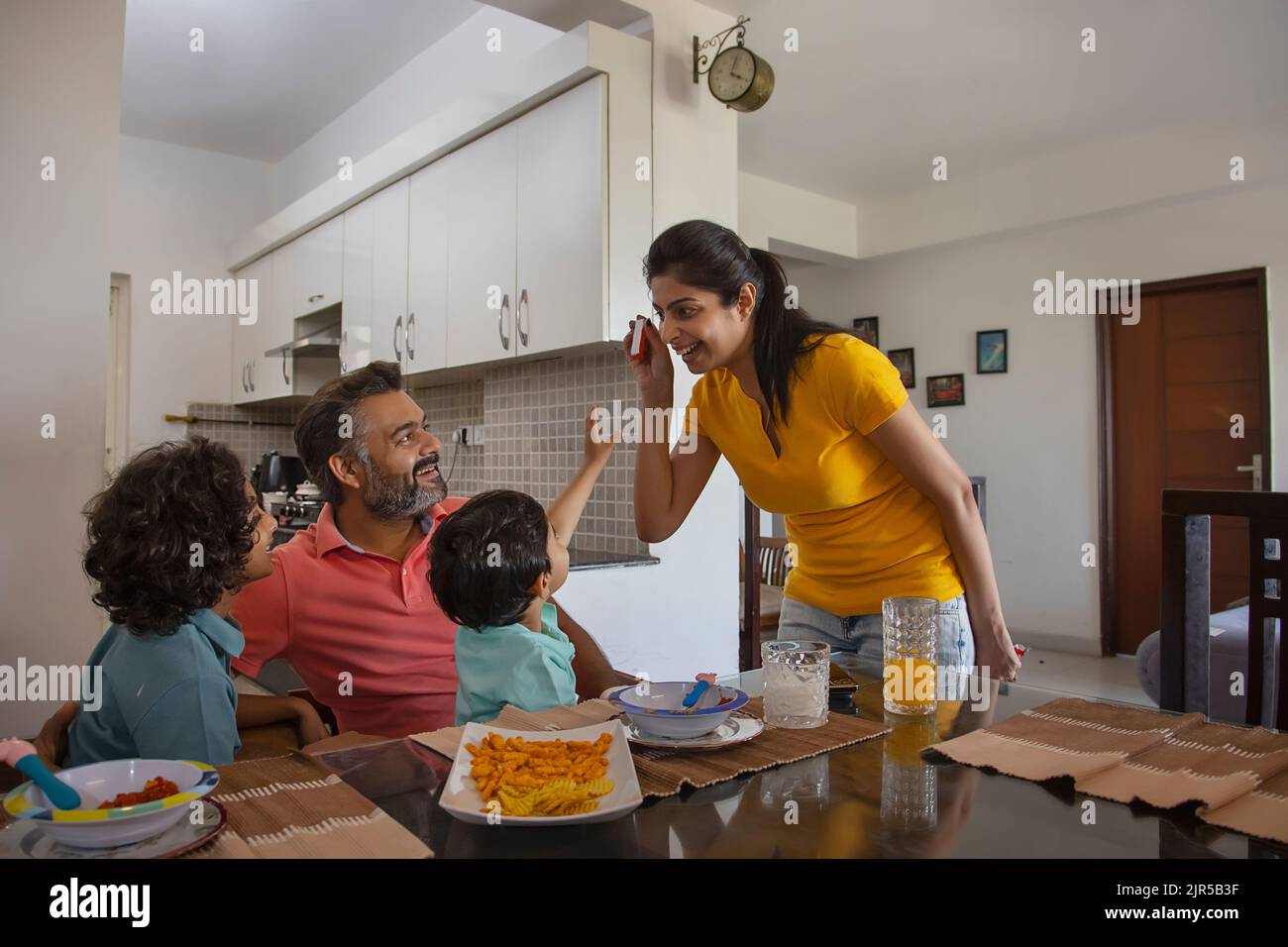 Portrait of a happy nuclear family having fun during breakfast Stock Photo