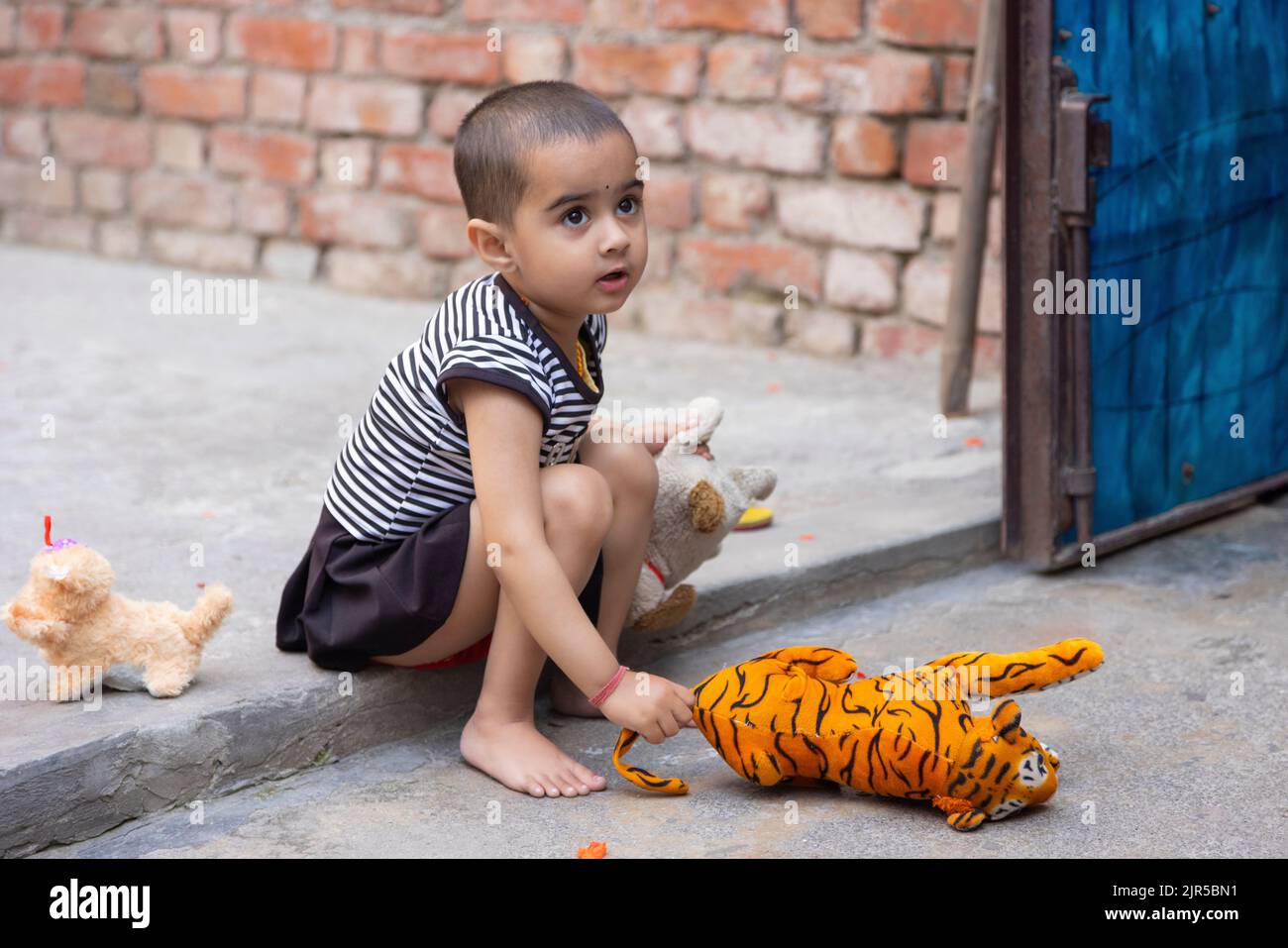 Portrait of a cute innocent child playing with the toys Stock Photo