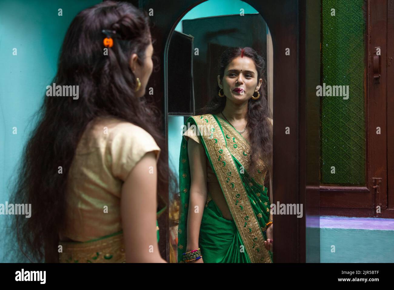 Beautiful woman doing make up in front of mirror Stock Photo